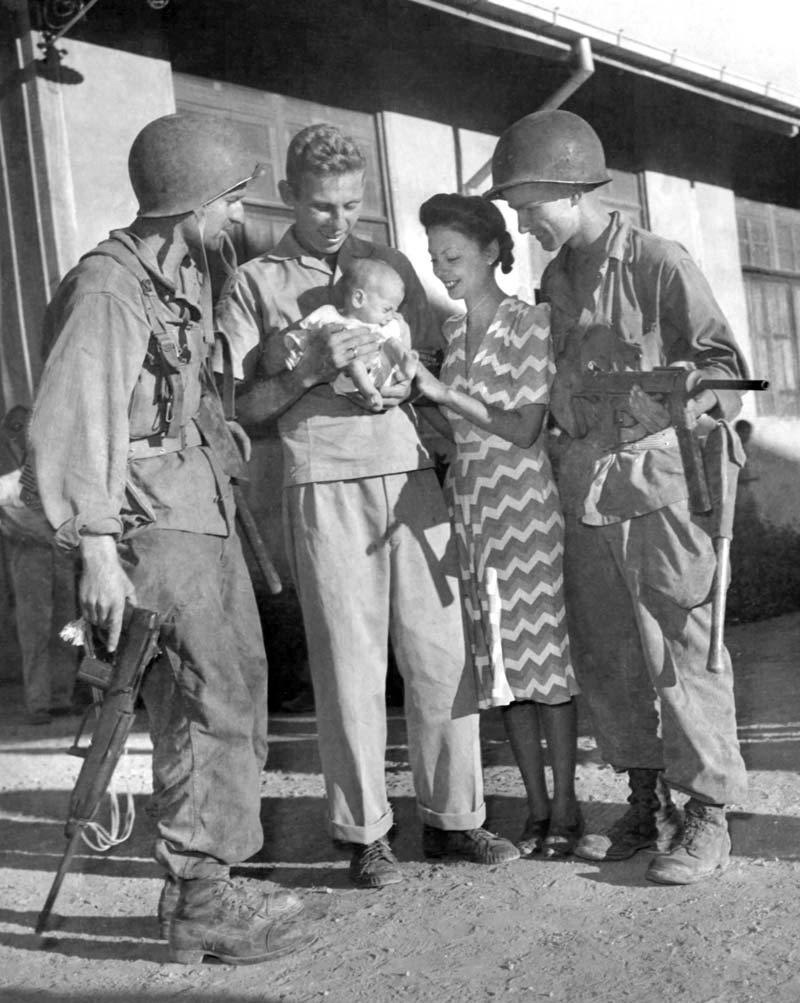 Former Los Baños internees with U.S. 11th Airborne soldiers after the rescue, February 23, 1945.